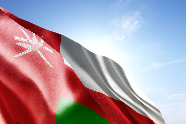 Flag of Oman waving in the wind Flag of Oman waving in the wind. Blue sunny sky in the background. Horizontal orientation. oman stock pictures, royalty-free photos & images