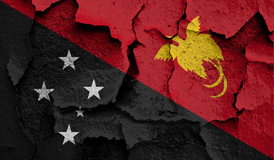 Flag of Papua New Guinea on old grunge wall in background