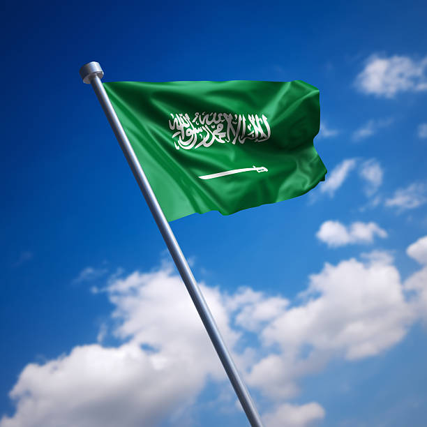 Flag of Saudi Arabia against blue sky stock photo