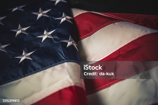 istock Flag of USA on dark background 1315319813