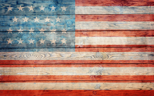 usa flag on old wooden wallDark wooden plank wall background with flag of USA