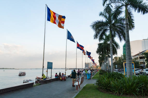 flags fly in the breeze at the southern end of riverside walk, phnom penh. - golden lion imagens e fotografias de stock