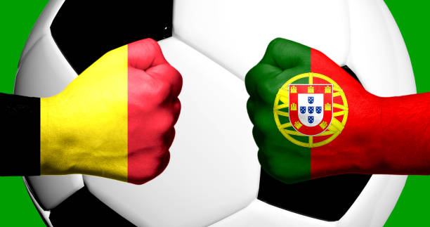 flags of belgium and portugal painted on two clenched fists facing each other with closeup 3d rendering football soccer ball in the background. mixed media football match game concept - world cup qualifying 個照片及圖片檔