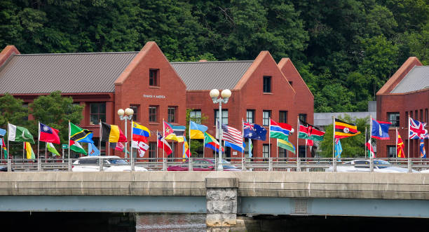 Flags waving on bridge over Saugatuck river in nice cloudy day stock photo