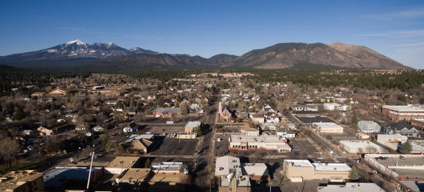 Flagstaff Arizona Town Skyline Aerial View Humphrey's Peak Aerial view over Flagstaff AZ looking north towards Humphreay's Peak in Coconino Natonal Forest flagstaff arizona stock pictures, royalty-free photos & images
