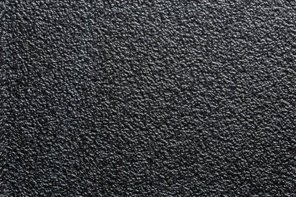 superficie plana de plástico resistente negro o de goma con acabado decorativo con baches - desigual con textura fotografías e imágenes de stock