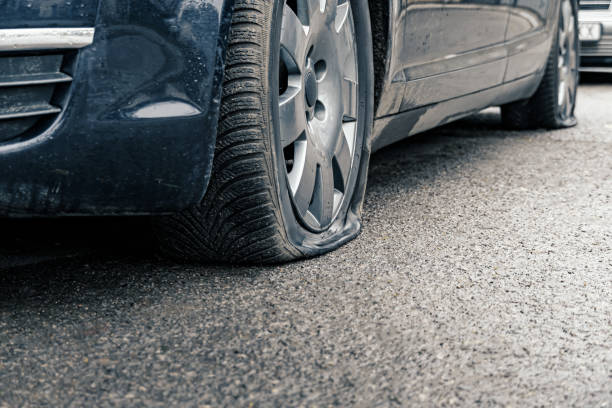flat car tire close up, punctured wheel stock photo