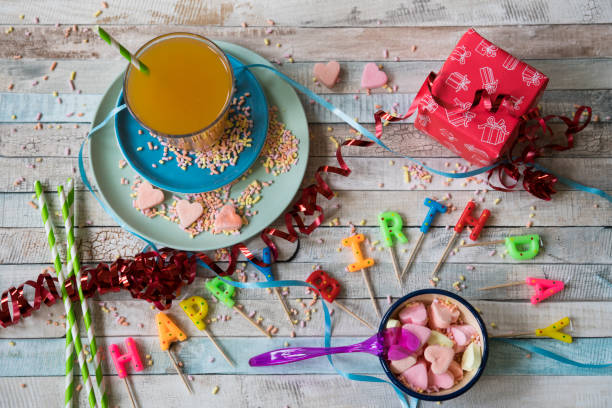 flat-lay-of-birthday-party-scene-with-drink-ribbon-heart-shape-candy-picture-id862262924