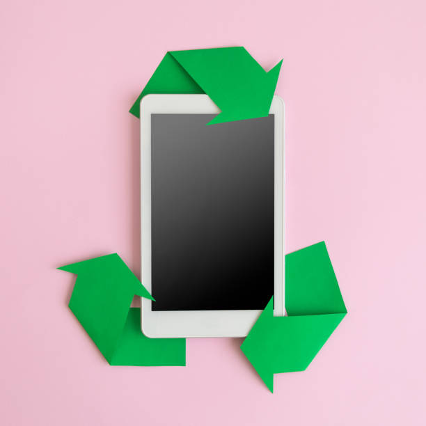 Flat lay of digital tablet device and recycling icon made of paper abstract. Blank screen, space for copy. stock photo