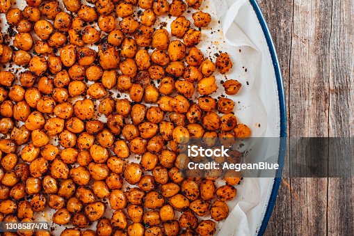 istock Flat Lay Roasted Spicy Snack Chickpeas in Tray 1308587478