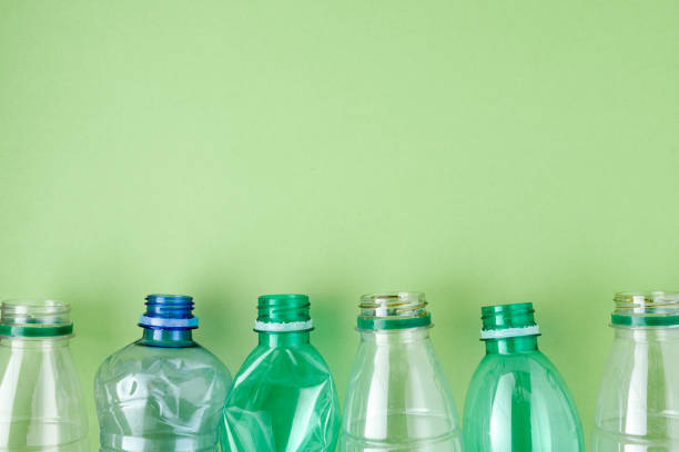 flat lay with plastic bottles isolated on green stock photo