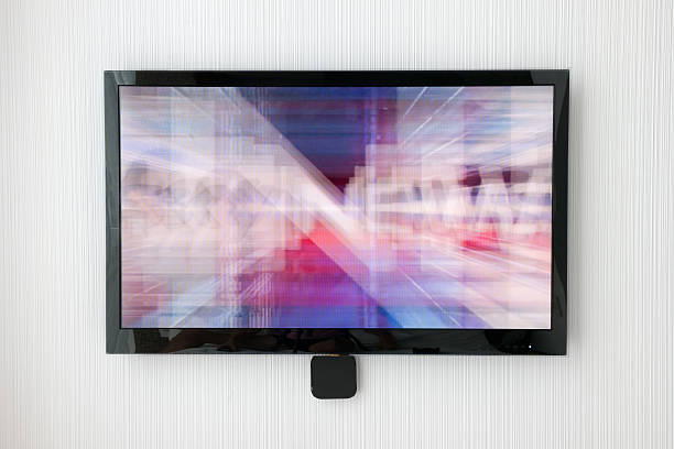 Flat Screen TV on Designer Wall (XXXL) Modern Large Flat Screen TV hanging on a textured Designer Wall. Nikon D3X. Converted from RAW. liquid crystal display stock pictures, royalty-free photos & images