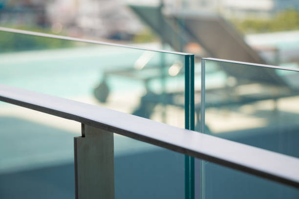 flat stainless railing closeup modern flat stainless railing and glass wall on outdoor building. bannister stock pictures, royalty-free photos & images