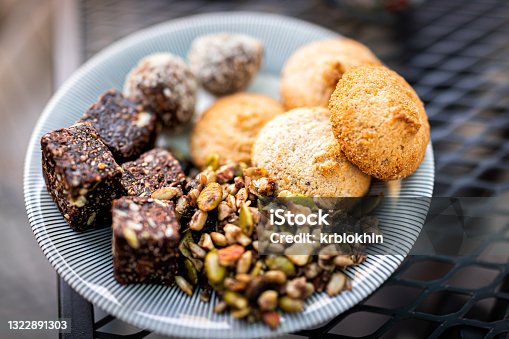 istock Flat top above closeup view of cookies on plate stack pile with raisin oatmeal vegan oat ingredient on wooden table 1322891303