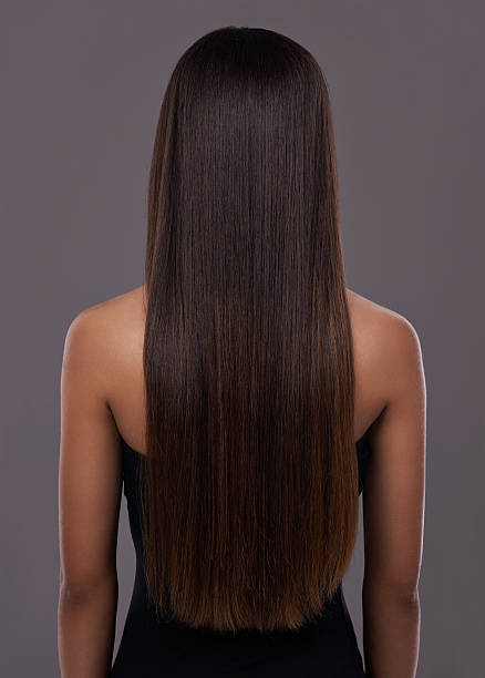 Flawless hair thanks to her trusty flat iron! Rear view of a young woman with beautiful long hair black hair stock pictures, royalty-free photos & images