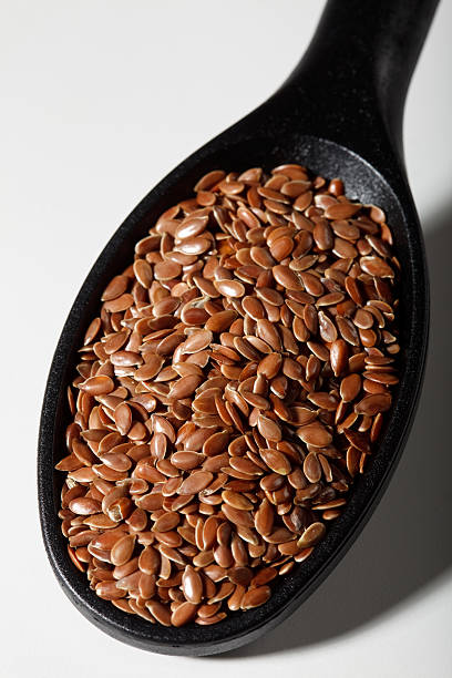 Flaxseed on spoon stock photo