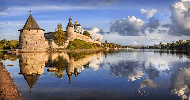 fleecy clouds Summer Evening on the river next to the Pskov Kremlin and big clouds in the blue sky pskov russia stock pictures, royalty-free photos & images