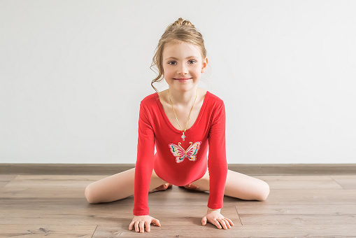 Little Girl Gymnast Sitting In The Splits Isolated On 
