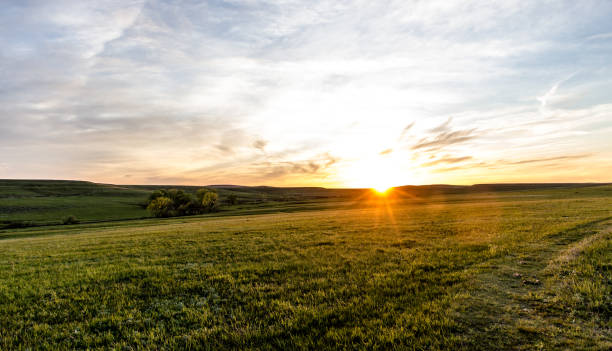Flint Hills Sunset Sunset over the rolling Flint Hills of Kansas grass area stock pictures, royalty-free photos & images