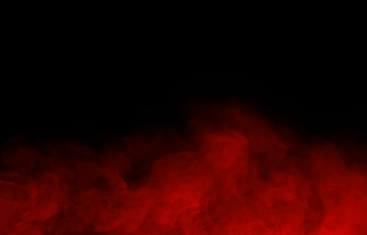Abstract close-up of colorful red mist or steam smoke. isolated on black background in mysterious darkness copy space