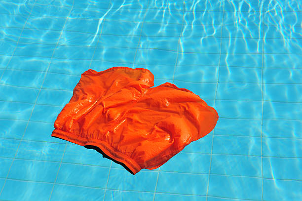 floating swimming shorts in the pool - zwembroek stockfoto's en -beelden