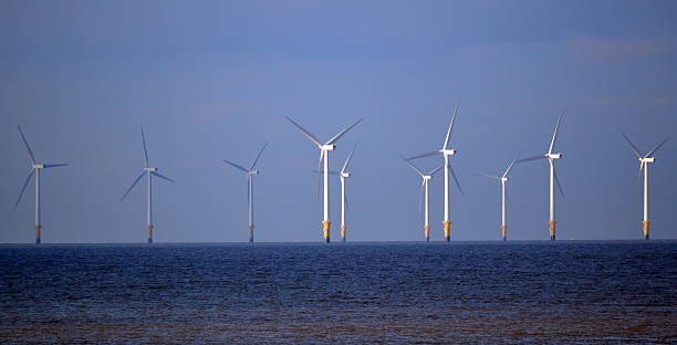 Floating Wind Turbines Floating wind turbines in the Irish Sea floating on water stock pictures, royalty-free photos & images