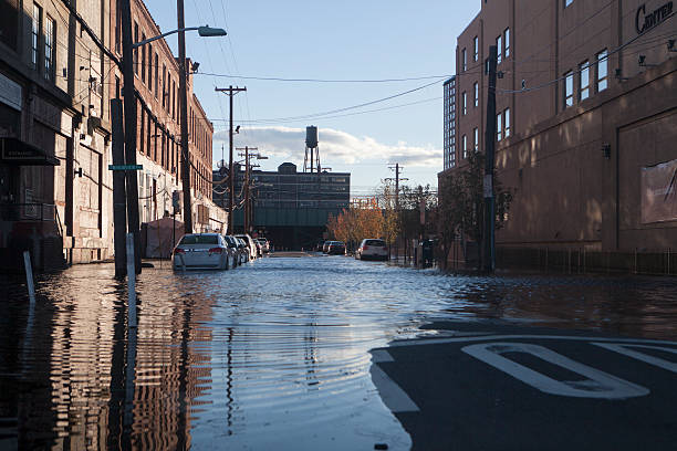 flooded street a flooded street in Hoboken, NJ after a water main break. new jersey street flooding stock pictures, royalty-free photos & images