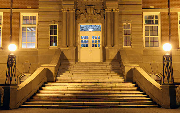 Floodlit Entrance to College Building at Night stock photo