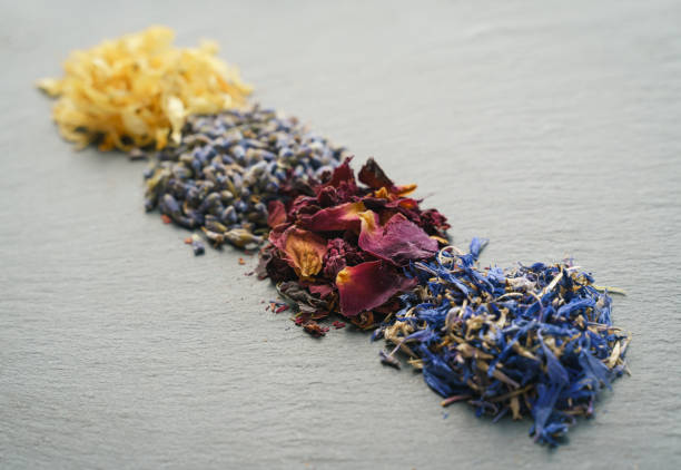 Floral herbs - dried marigold, lavender, rose and cornflower petals as ingredients for cooking stock photo