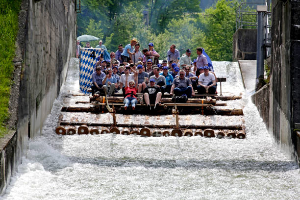 Flossrutsche Schaeftlarn, Bavaria, Germany - May 19, 2017: Typical bavarian raft ride on the river isar, a party with tradtional music. People having fun. Rafting on the Isar River, Muehltal raft slide, the largest raft slide in Europe, Bavaria, Germany river isar stock pictures, royalty-free photos & images