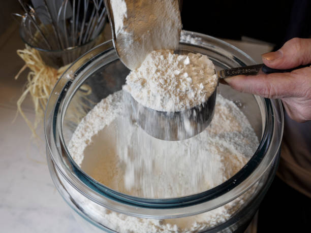 Flour Poured from Scoop into Measuring Cup Proper Method stock photo