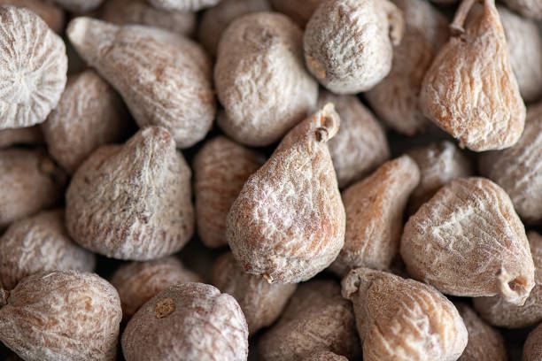 Flour-dusted dried figs originating from Spain, delicious produce of Ficus carica tree, healthy and nutritious snack stock photo