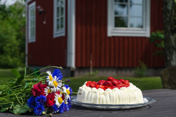 Flowers and strawberry cake on a table stock photo