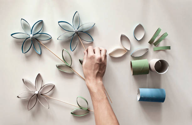 Flowers from toilet roll tube for Mother Day, zero waste craft for kids, neutral pastel background stock photo