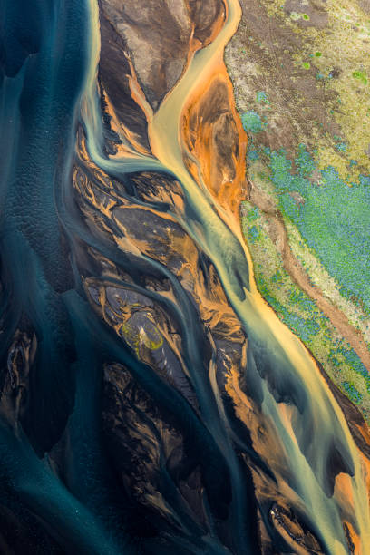 A flowing landscape of Icelandic glacial rivers A dream-like landscape of Iceland, with flowing glacial rivers, taken from a helicopter. geology photos stock pictures, royalty-free photos & images
