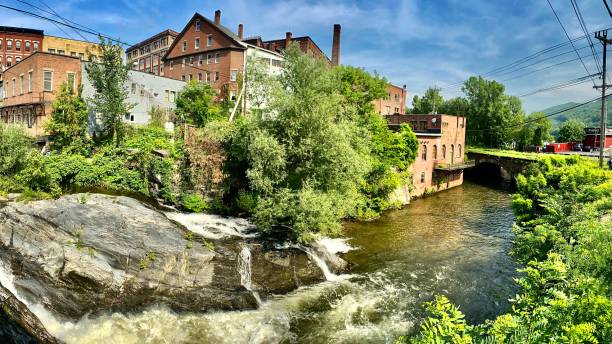 flowing whetstone brook with historic downtown brattleboro, vermont touring historic brattleboro, vt - usa samuel howell stock pictures, royalty-free photos & images