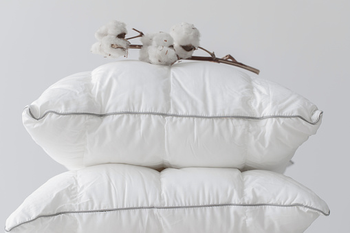 Clean white cotton pillows on white background.