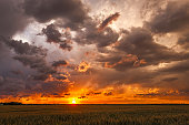 istock Fly-Away Sunset: disintegrating storm clouds dispersing at sunset 1333863903