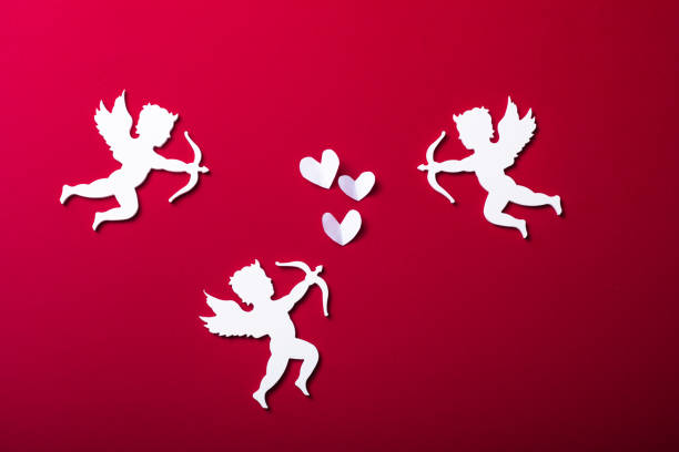 Flying cupid silhouette,  happy Valentine's Day banners, paper art style. Amour on red paper stock photo