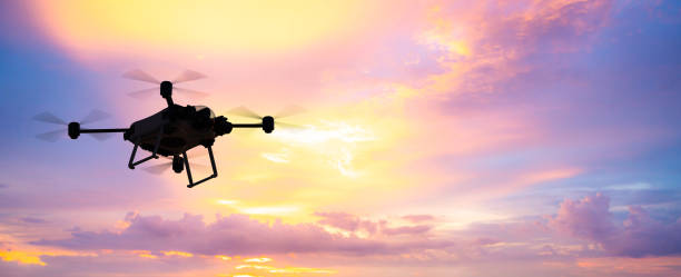 flying drone in sky 3d rendering silhouette flying drone in twilight sky background multicopter stock pictures, royalty-free photos & images