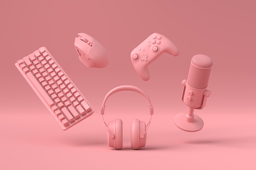 Flying gamer monochrome gears like mouse, keyboard, joystick, headset, VR Headset, microphone on pink table background. 3d rendering of accessories for live streaming concept top view