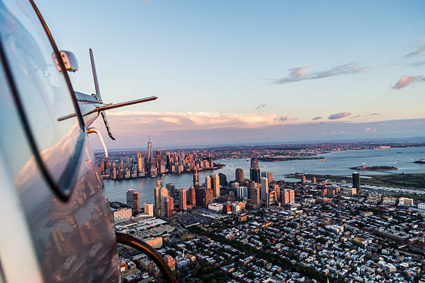 Flying High and Looking back! Flying away from Manhattan over to landing site, looking back is the magnificent skyline of Manhattan, New York helicopter stock pictures, royalty-free photos & images