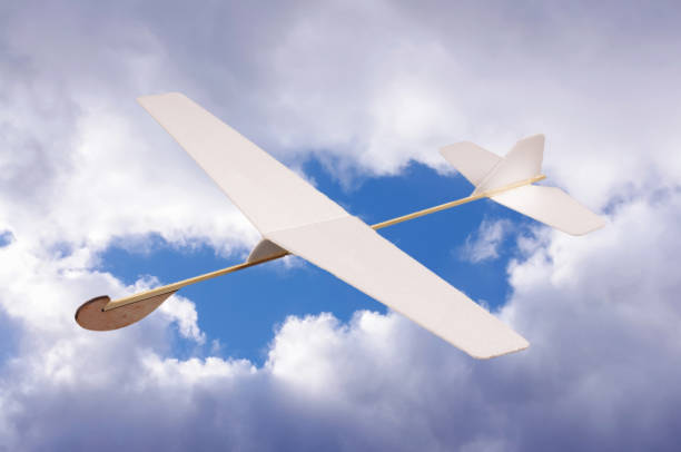 DIY foam board plane in front of cloudy sky Toy foam board airplane in front of cloudy sky foamcore stock pictures, royalty-free photos & images