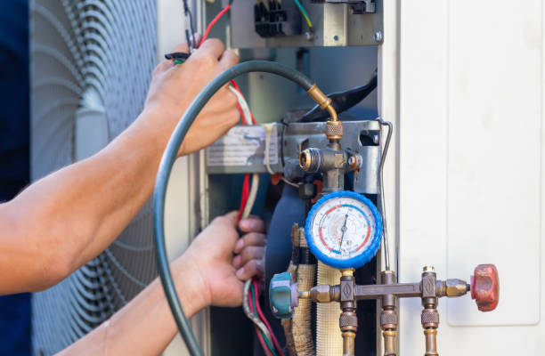 Focus at the pressure gauge, Technician team checking leakage air conditioning system, Air Conditioning Repair man checking and fixing modern air conditioning system stock photo