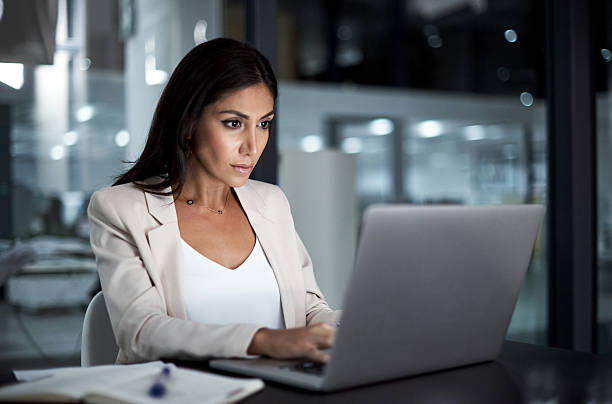 Focused on doing her best work Shot of a young businesswoman using a laptop at work beautiful arab woman stock pictures, royalty-free photos & images