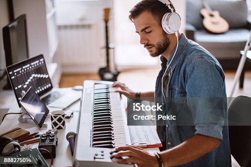 istock Focused Young Artist Playing Electric Piano 888275014