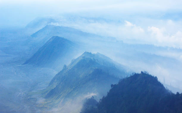 Fog covers the hills in Bromo Tengger Semeru National Park stock photo