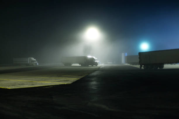 Foggy Midnight Expressway Semi Trailer Truck Rest Stop stock photo