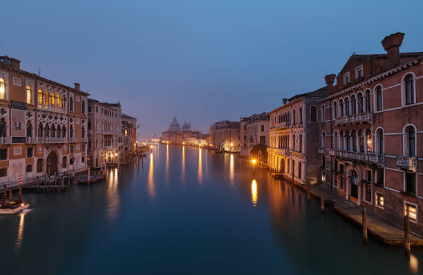 VENICE, ITALY - February 17, 2020: Foggy morning at Grand Canal and in the background the Basilica Santa Maria della Salute,view from Ponte dell' Accademia bridge stock photo