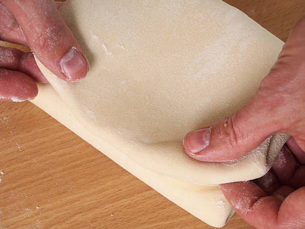 Fold up dough. Fold the lower third of the pastry over the centre...